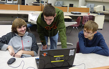 Three students working on strategy